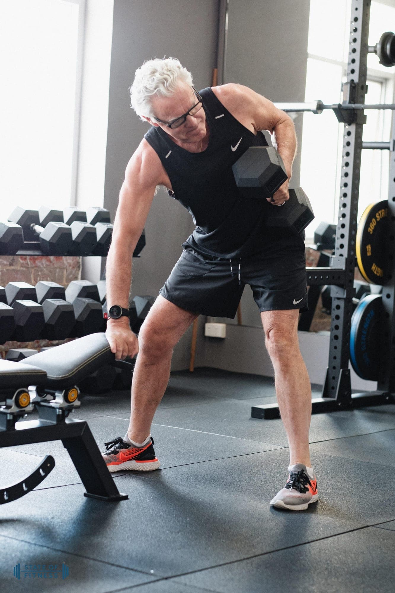 An older member performing a single-arm dumbbell row during a strength session at State of Fitness in South Yarra.