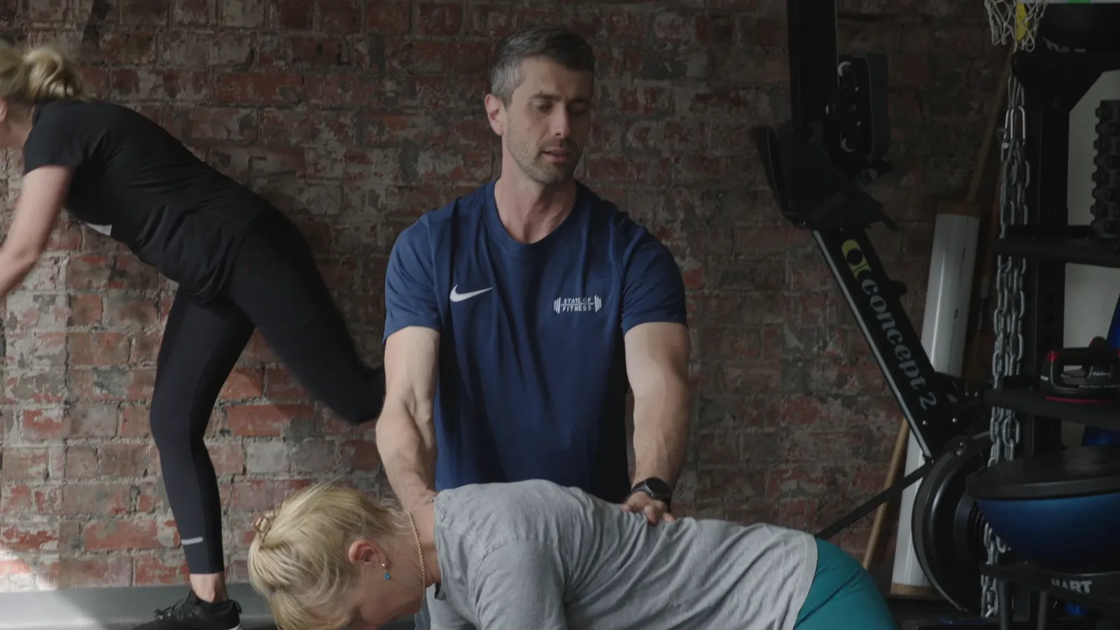 Dylan coaching a member through a lift at the State of Fitness studio in South Yarra