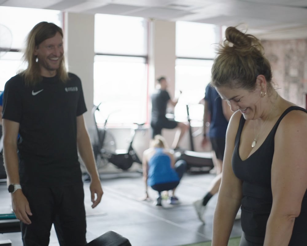 A woman is undergoing personal training along with her personal expert coach.